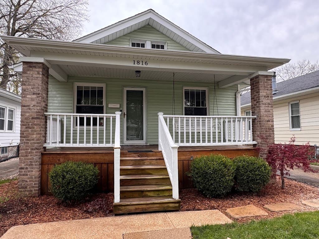 Charming brick and siding bungalow home with a clean, freshly washed exterior